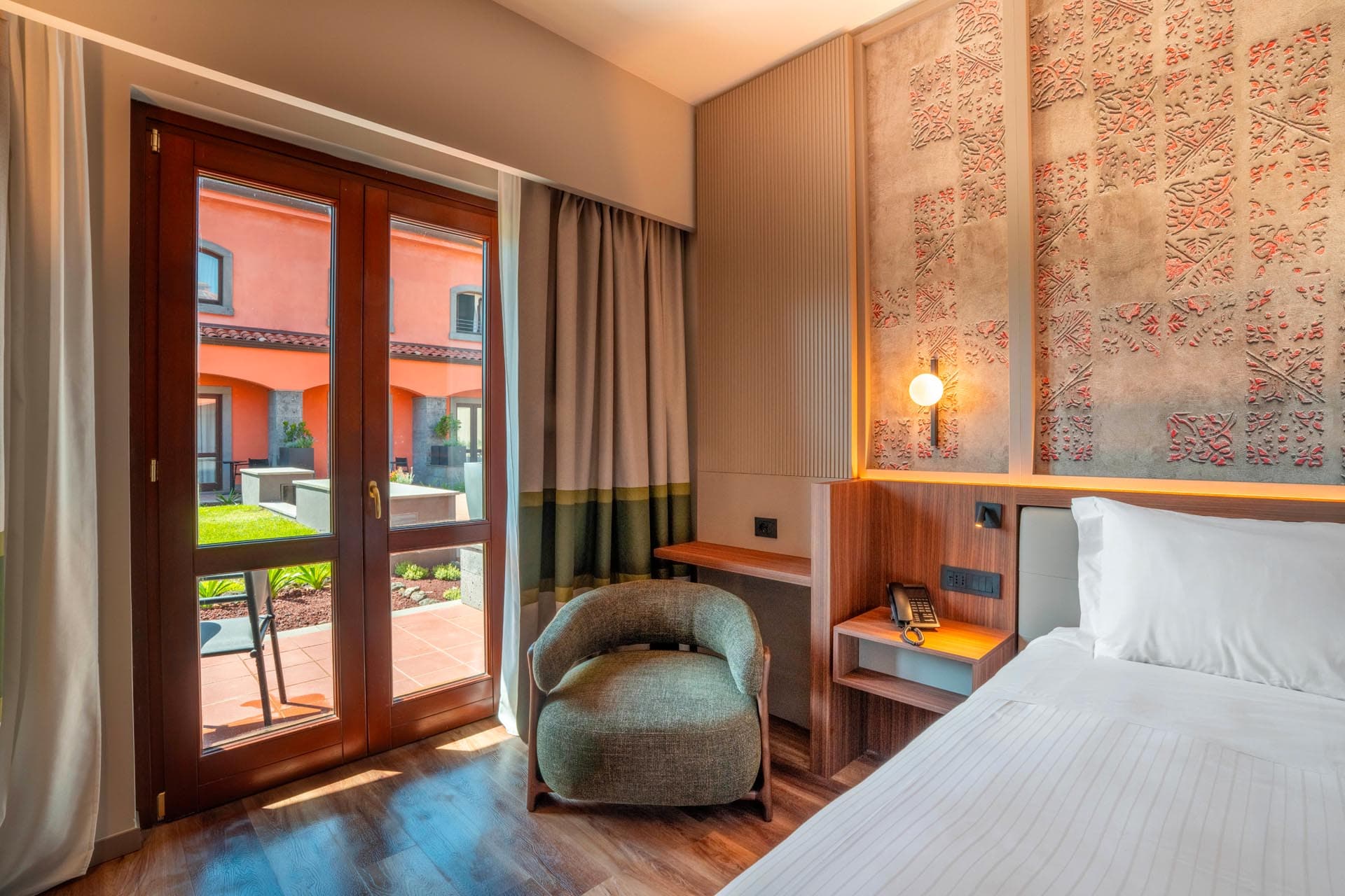 Room with king-size bed and patio